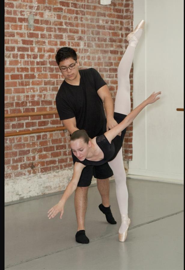 Valley Dance Theatre dancers in a partnering lift at the studio